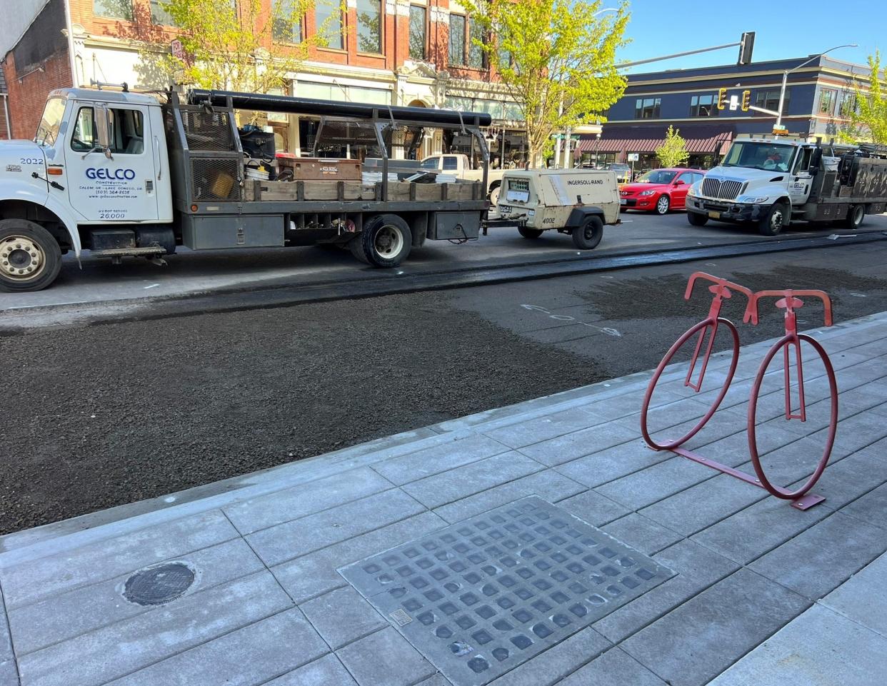 A grid of purple glass blocks was repurposed in the new sidewalk in front of the Bike Peddler on Commercial Street NE, even though it no longer illuminates a vault below. The city contracted with Gelco Construction to fill the vault with cement and rock.