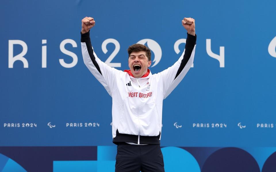 PARIS, FRANCE - SEPTEMBER 07: Gold medalist, Finlay Graham of Team Great Britain, celebrates on the podium during the medal ceremony for the Men's C1-3 Road Race on day ten of the Paris 2024 Summer Paralympic Games at on September 07, 2024 in Paris, France