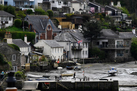 A union jack flutters as locals play by the harbour in Newton Ferrers, Devon, Britain April 12, 2017. REUTERS/Dylan Martinez