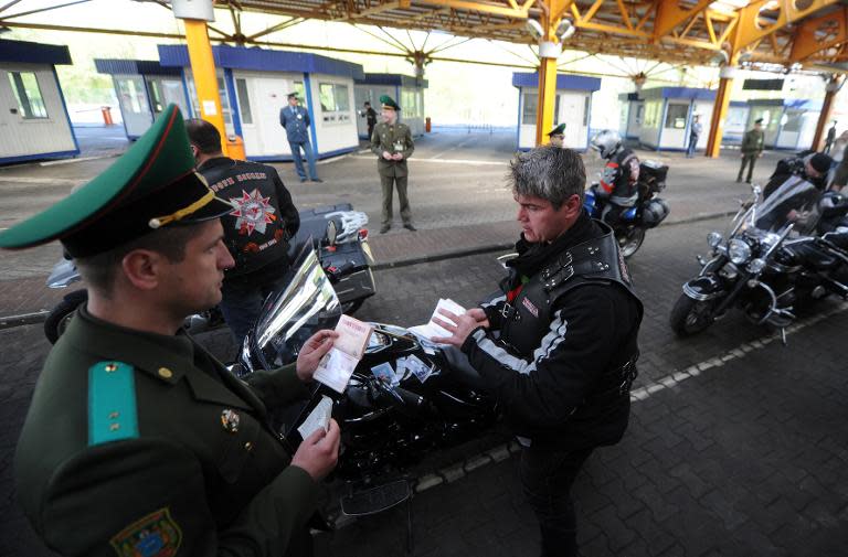 Belarus border guards check members of the Russian Night Wolves Motorcycle Club at a border crossing with Poland near Brest on April 27, 2015