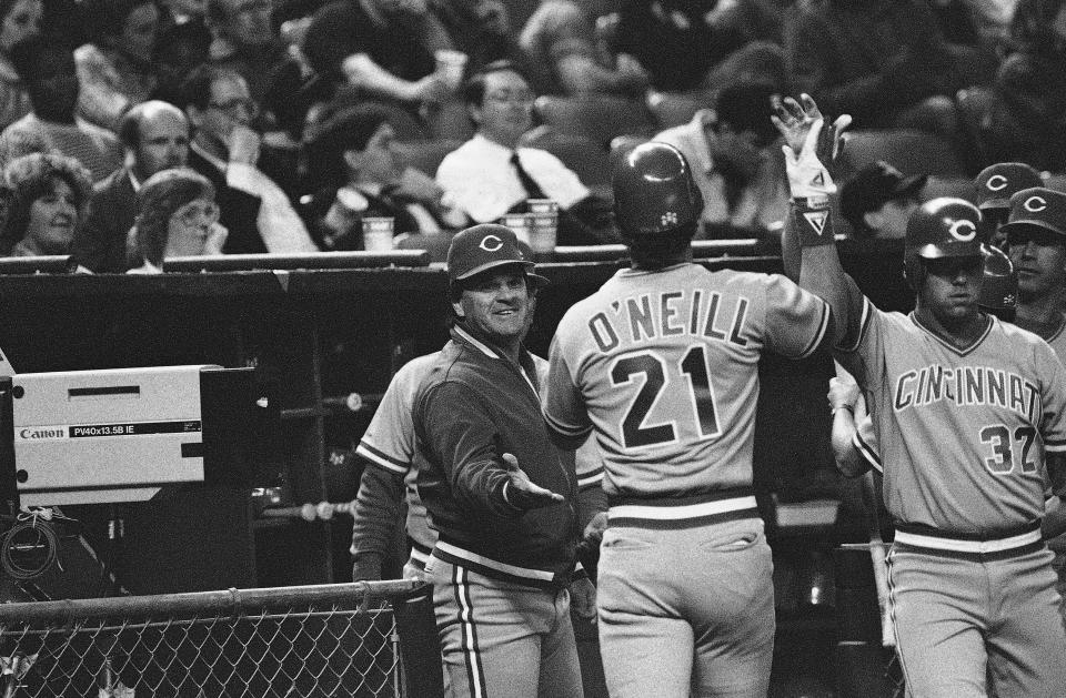 Cincinnati Reds manager Pete Rose congratulates Cincinnati Red Paul O'Neill (21) after he scored on an error by Houston Astros Ken Caminiti in sixth inning action. The Reds won by a score of 8-3, April 11, 1989, at the Astrodome.