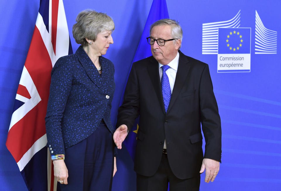 European Commission President Jean-Claude Juncker prepares to shake hands with British Prime Minister Theresa May before their meeting at the European Commission headquarters in Brussels, Thursday, Feb. 7, 2019. (AP Photo/Geert Vanden Wijngaert)