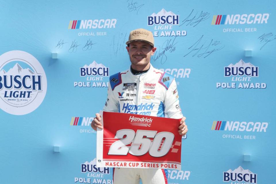 Apr 13, 2024; Fort Worth, Texas, USA; NASCAR Cup Series driver Kyle Larson (5) celebrates Hendrick Motor Sports 250th NASCAR Cup Series pole after qualifying for the NASCAR Cup Series AutoTrader EchoPark Automotive 400 at Texas Motor Speedway. Michael C. Johnson/USA TODAY Sports