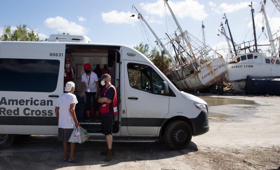 Members of the Red Cross distribute meals to crews who work the boats and shrimp docks on Fort Myers Beach on Nov. 8, 2022. The shrimping industry was severely impacted by Hurricane Ian. Most of the fleet was washed onto land by the storm surge.