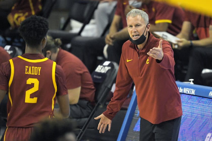 Southern California head coach Andy Enfield, right, yells at guard Tahj Eaddy during the first half of an NCAA college basketball game against UCLA Saturday, March 6, 2021, in Los Angeles. (AP Photo/Mark J. Terrill)