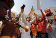 Supporters of the India's Bharatiya Janata Party (BJP) celebrate after learning of the initial poll results at Gandhinagar in the western Indian state of Gujarat May 16, 2014. REUTERS/Amit Dave