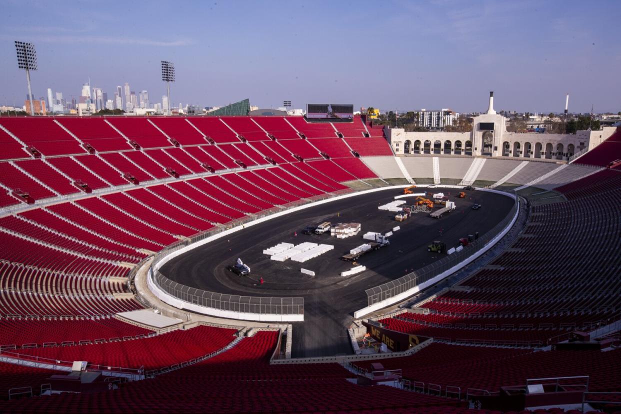 Construction crews transform the Coliseum from a football stadium to a quarter-mile short track NASCAR exhibition race track.