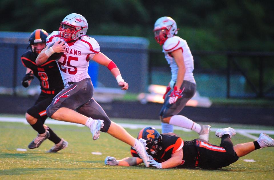 Northwest running back Connor Satterfield breaks a tackle by Marlington's Carter Difloure, Friday, Aug. 25, 2023.