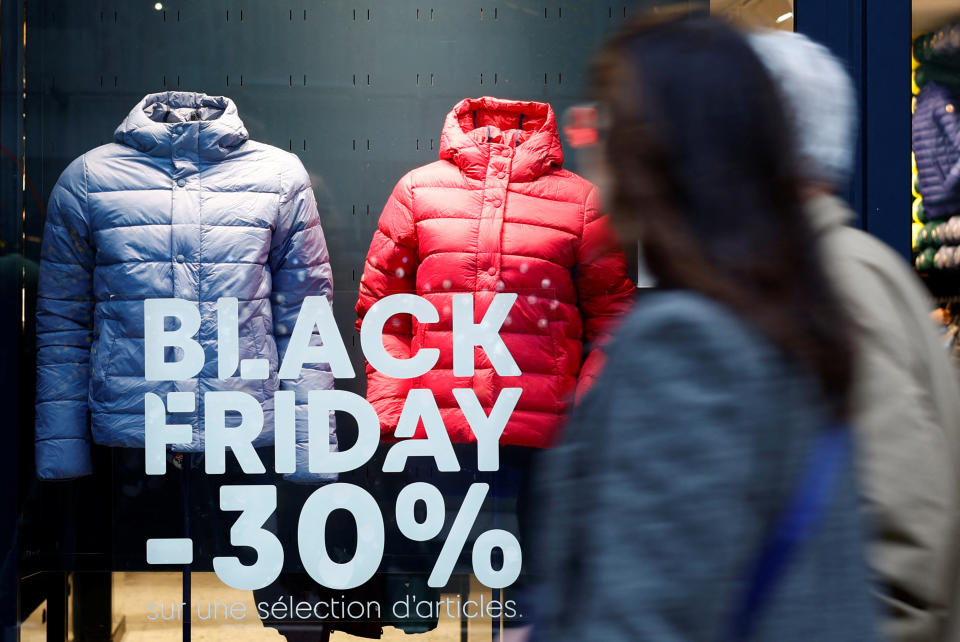 People walk past a Black Friday sale sign displayed on a shop window in Paris, France, November 23, 2023. REUTERS/Sarah Meyssonnier