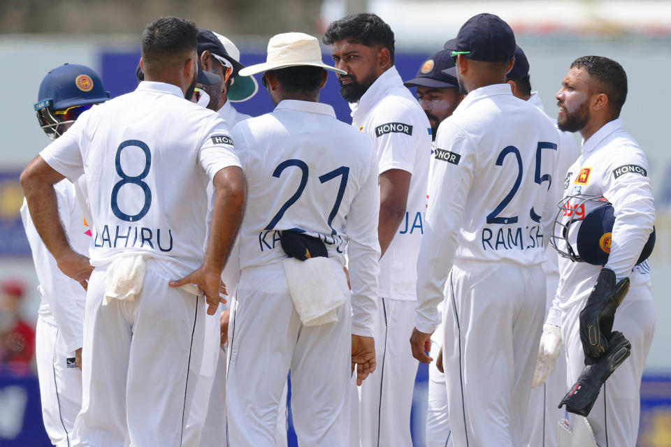 Sri Lanka's Prabath Jayasuriya, center, is surrounded by teammates as he celebrates the wicket of New Zealand's Tom Blundell on the third day of the first cricket test match between New Zealand and Sri Lanka in Galle, Sri Lanka, Friday, Sept. 20, 2024. (AP Photo/Viraj Kothalawala)