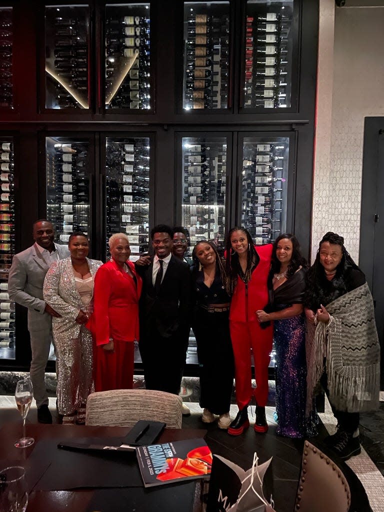 Brittany "Chi" Coney and Denisia "Blu June" Andrews pose with their family to celebrate the history-making moment for "Cuff It" winning in the Best R&B Category at the 65th Annual Grammy Awards.