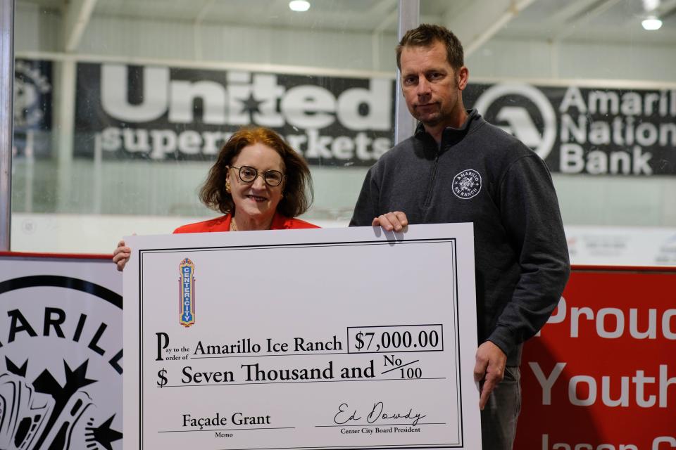 Center City Executive Director Beth Duke presents a $7,000 Facade Grant to Eric Andersen, president and owner of the Amarillo Ice Ranch, on Tuesday, Nov. 16.