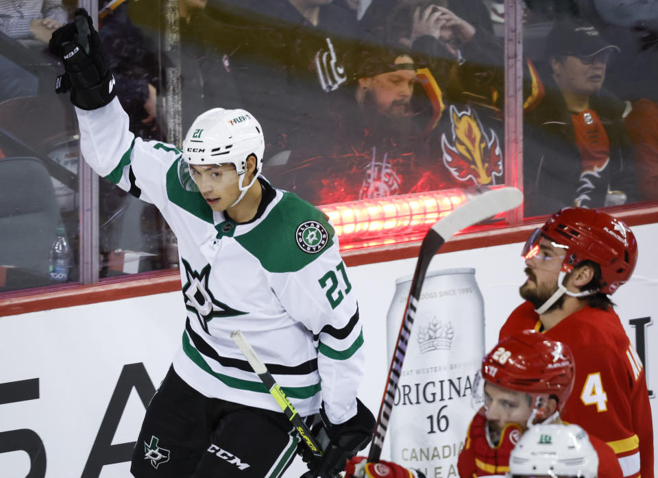 Dallas Stars forward Jason Robertson, left, celebrates his goal as Calgary Flames defenseman Rasmus Andersson looks on during the second period of an NHL hockey game, Wednesday, Nov. 1, 2023 in Calgary, Alberta. (Jeff McIntosh/The Canadian Press via AP)