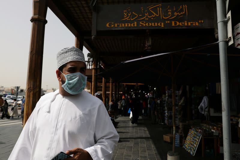 A man wears a protective face mask, following the outbreak of the new coronavirus, as he walks at the Grand Souq in old Dubai