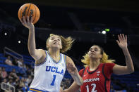 UCLA guard Kiki Rice, left, shoots as Arizona forward Esmery Martinez defends during the second half of an NCAA college basketball game Friday, Feb. 3, 2023, in Los Angeles. (AP Photo/Mark J. Terrill)