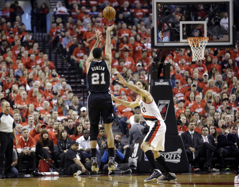 Portland Trail Blazers' Robin Lopez (42) defends against San Antonio Spurs' Tim Duncan (21) in the first quarter of Game 3 of a Western Conference semifinal NBA basketball playoff series Saturday, May 10, 2014, in Portland, Ore. (AP Photo/Rick Bowmer)