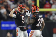 Cincinnati Bengals quarterback Joe Burrow (9) celebrates a touchdown pass to Ja'Marr Chase with Joe Mixon during the second half of an NFL football game against the San Francisco 49ers, Sunday, Dec. 12, 2021, in Cincinnati. (AP Photo/Aaron Doster)