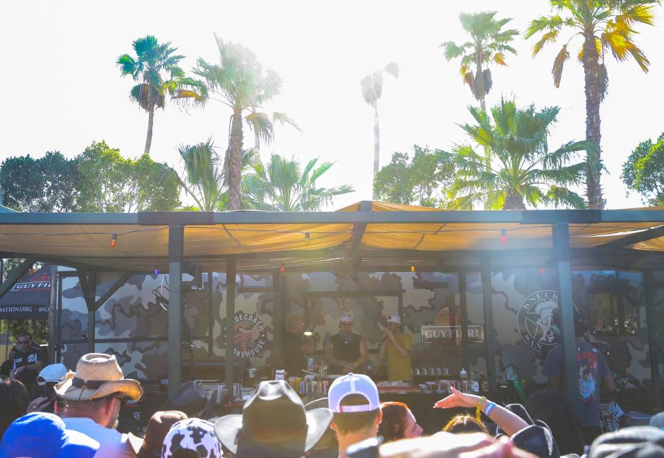 Guy Fieri hosts a cooking demonstration with Hardy and Bailey Zimmerman at Guy Fieri's Smokehouse during Stagecoach country music festival in Indio, Calif., Sunday, April 28, 2024.