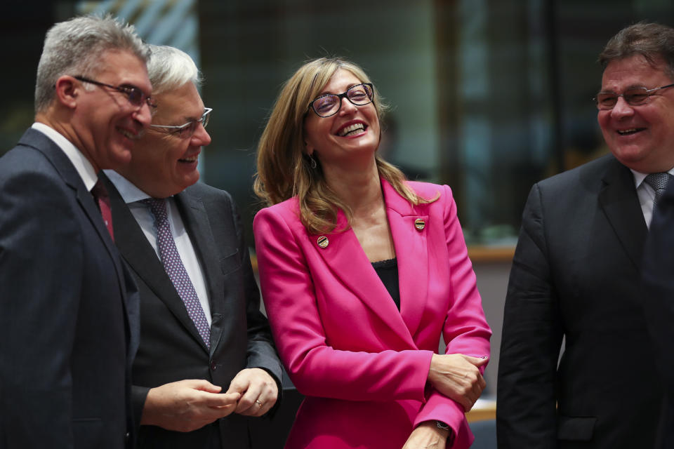 Bulgarian Foreign Minister Ekaterina Zaharieva, second right, talks to Malta's Foreign Minister Carmelo Abela, left, Lithuanian Foreign Minister Linas Linkevicius, right, and Belgium Foreign Minister Didier Reynders during an European Foreign Affairs Ministers meeting at the Europa building in Brussels, Monday, Nov. 11, 2019. European Union foreign ministers are discussing ways to keep the Iran nuclear deal intact after the Islamic Republic began enrichment work at its Fordo power plant. (AP Photo/Francisco Seco)