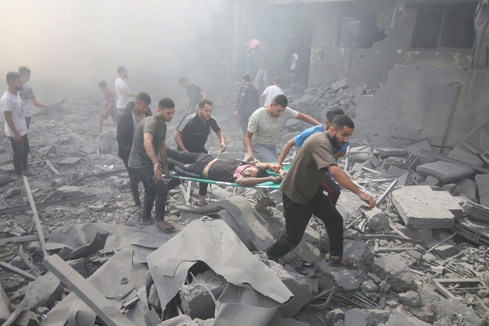 Palestinians evacuate wounded people after an Israeli airstrike in Rafah refugee camp, southern Gaza Strip, Thursday, Oct. 12, 2023.