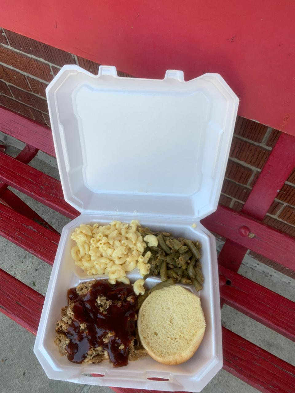 A pulled pork sandwich, macaroni and cheese and green beans from BBQ Train are pictured May 20, 2022.