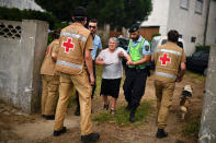 <p>People are evacuated from their houses by Red Cross and police due the proximity of a dangerous wildfire at Torgal, Castanheira de Pera, Portugal, June 18, 2017. (Patricia De Melo Moreira/AFP/Getty Images) </p>