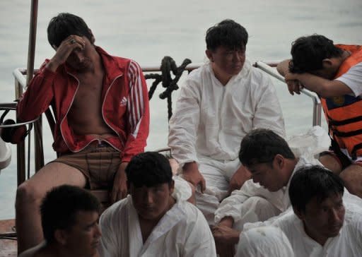 Asylum-seeker survivors are seen onboard an Indonesian rescue boat at Merak seaport. Fifty-four people -- mostly males and all believed to be Afghans -- were plucked from the ocean after their wooden boat broke up and sank early on Wednesday morning. Some had been languishing in the water for over 24 hours