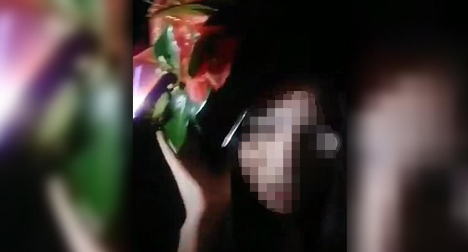 One of the teenager’s can be seen placing the wreath onto her head. Source: 7 News