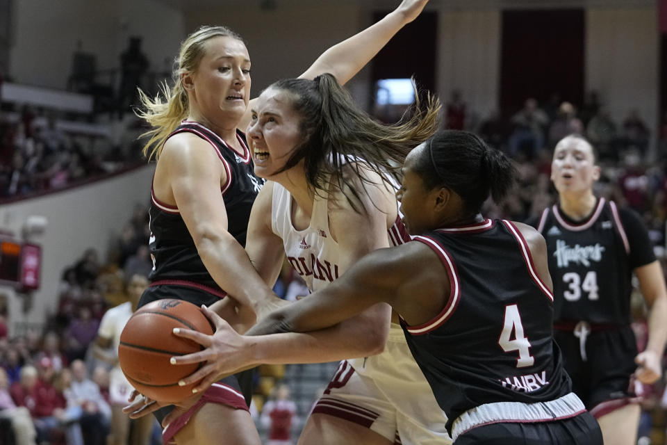 Indiana's Mackenzie Holmes, center, is double-teamed by Nebraska's Alexis Markowski, left, and Sam Haiby during the second half of an NCAA college basketball game, Sunday, Jan. 1, 2023, in Bloomington, Ind. (AP Photo/Darron Cummings)