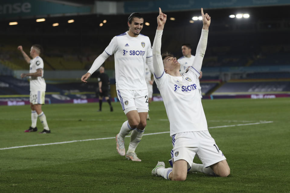 Leeds United's Diego Llorente, front, celebrates after scoring his side's opening goal during the English Premier League soccer match between Leeds United and Liverpool at the Elland Road stadium in Leeds, England, Monday, April 19, 2021. (Lee Smith/Pool via AP)