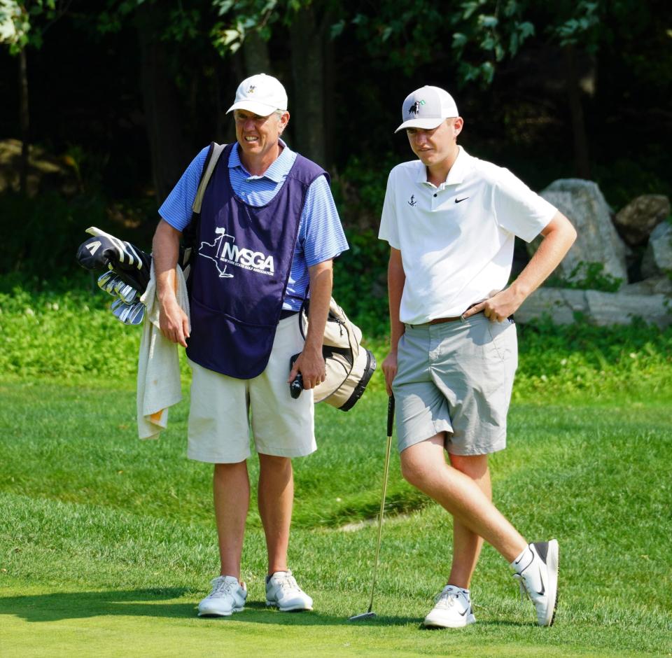 Winged Foot member and Vanderbilt rising sophomore Ben Loomis waits to putt on the 17th green next to his caddie and father Mark Loomis during the final round of the 100th New York State Amateur at Wykagyl Country Club on August 9, 2023.