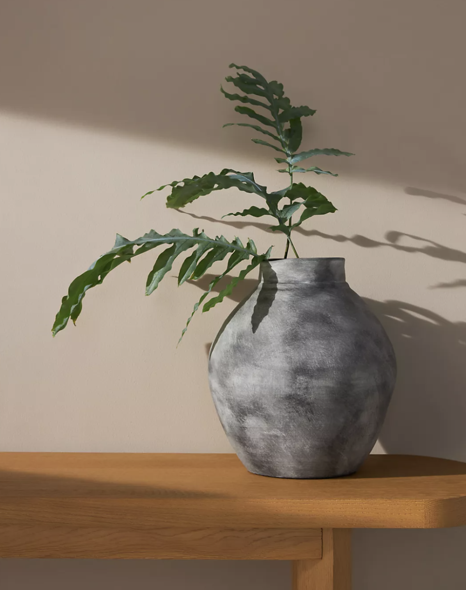 Gray terracotta vase with leaves