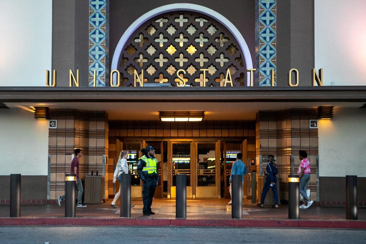 A security guard stands at the front entrance of Union Station=