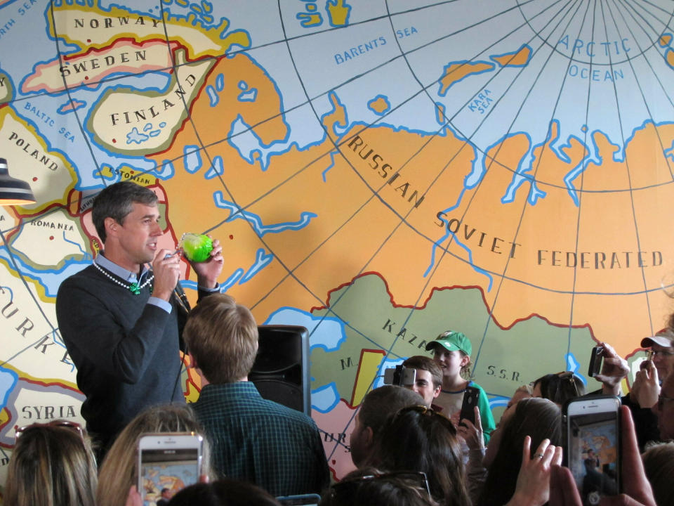 Democratic presidential candidate Beto O'Rourke speaks to supporters at a coffee shop on Sunday, March 17, 2019, in Madison, Wisconsin. O'Rourke came in wearing a green cabbage St. Patrick's Day necklace given to him by a supporter during breakfast. (AP Photo/Scott Bauer)