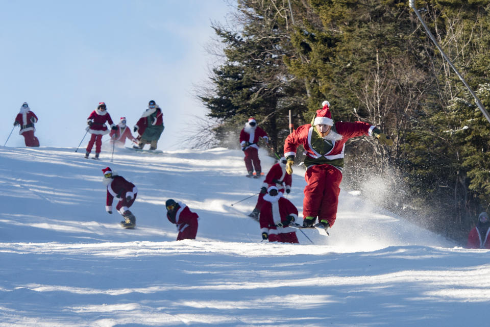 Skiers and snowboarders donning Santa suits and beards hit the slopes for the 17th annual Santa Sunday in Maine.