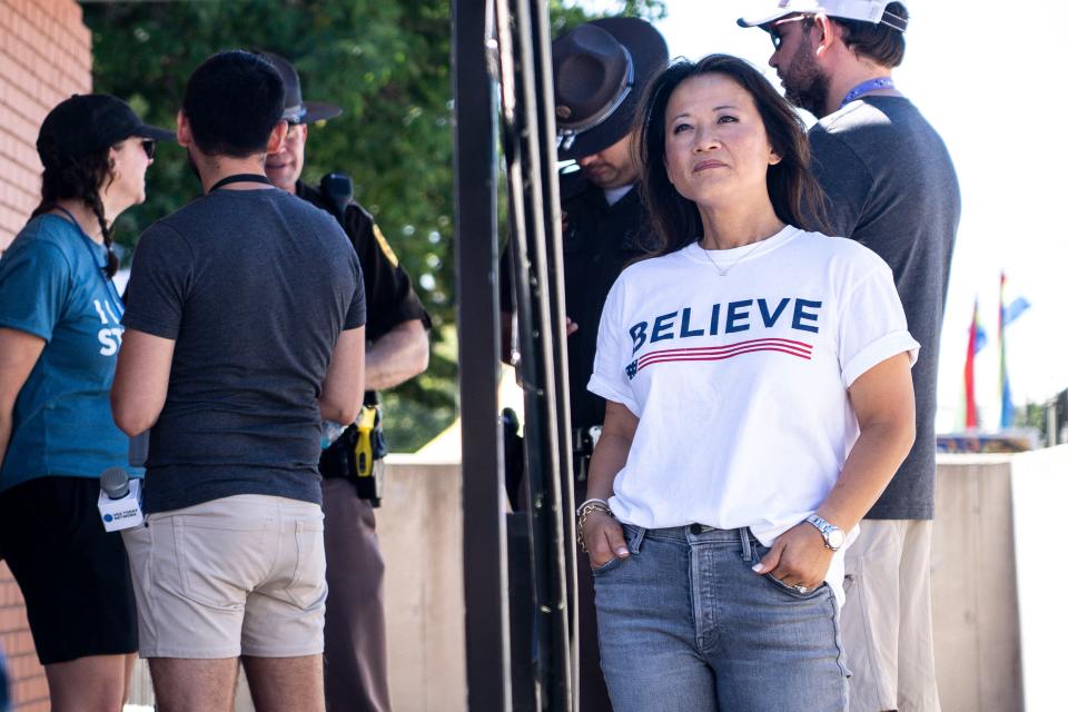 GOP presidential candidate Ryan Binkley's wife, Ellie, watches as he speaks at the Iowa State Fair on Aug. 12 in Des Moines.