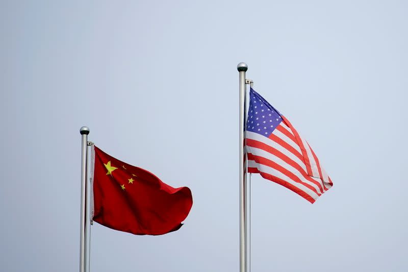 FILE PHOTO: Chinese and U.S. flags flutter outside a company building in Shanghai