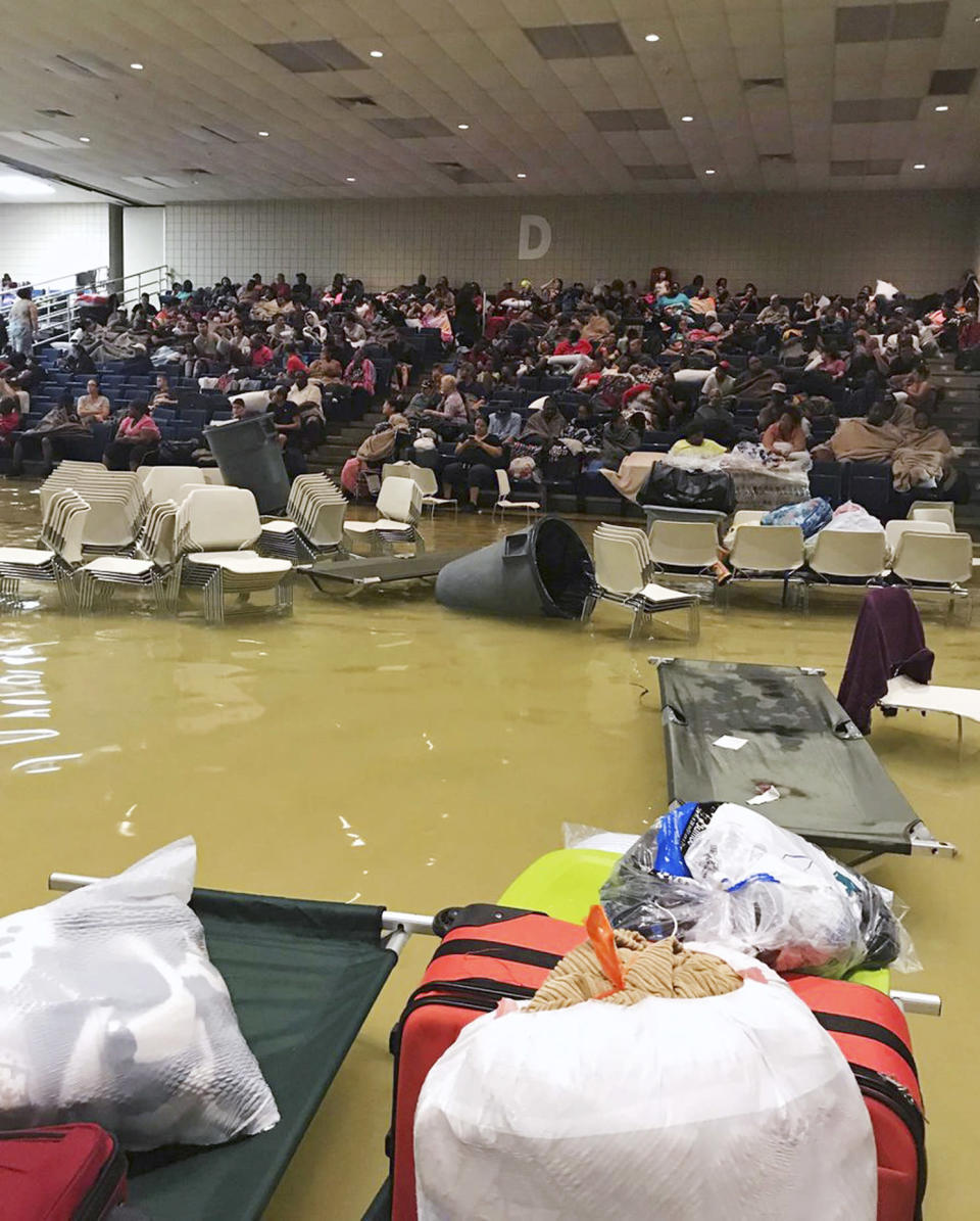 <em>Evacuees sit in the bleachers at the Bowers Civic Center in Port Arthur, Texas (AP)</em>