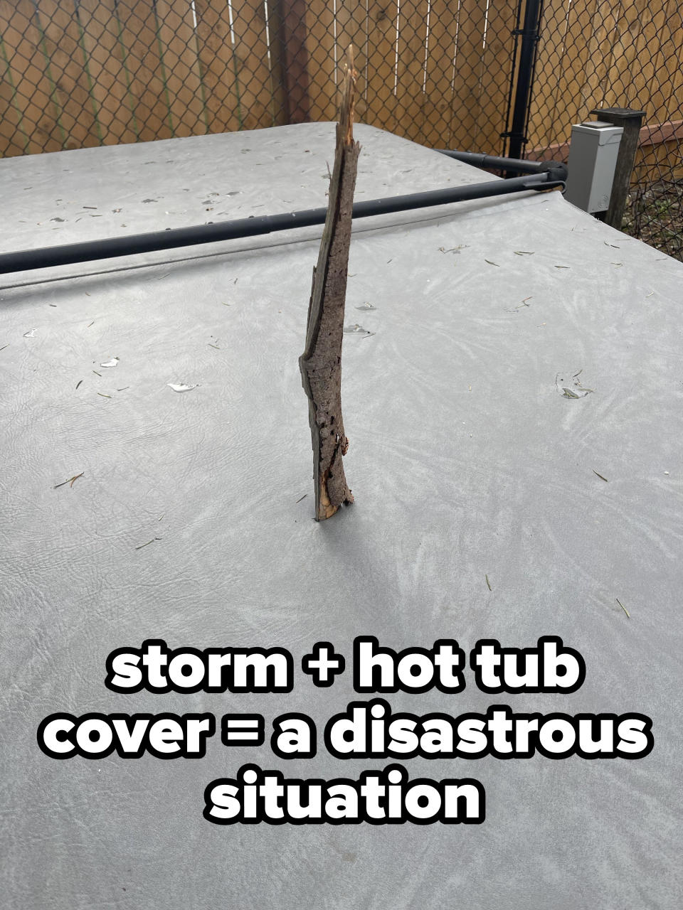 A tree branch sticking out of a hot tub cover