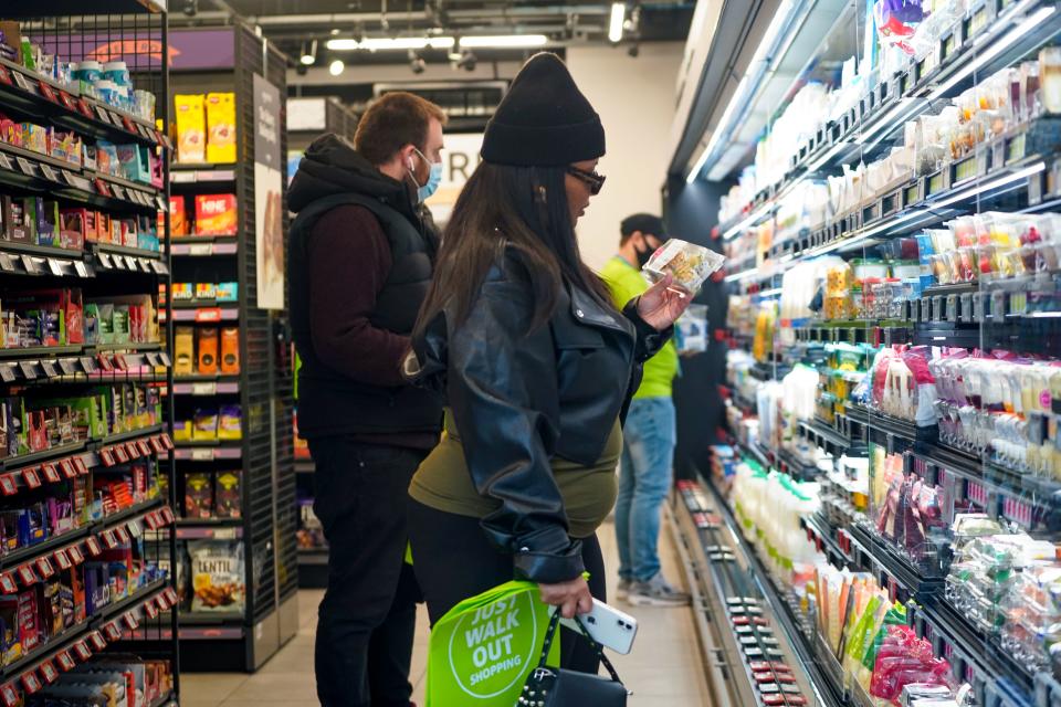 Customers shop for goods inside Amazon's new Amazon Fresh store in Ealing, west London