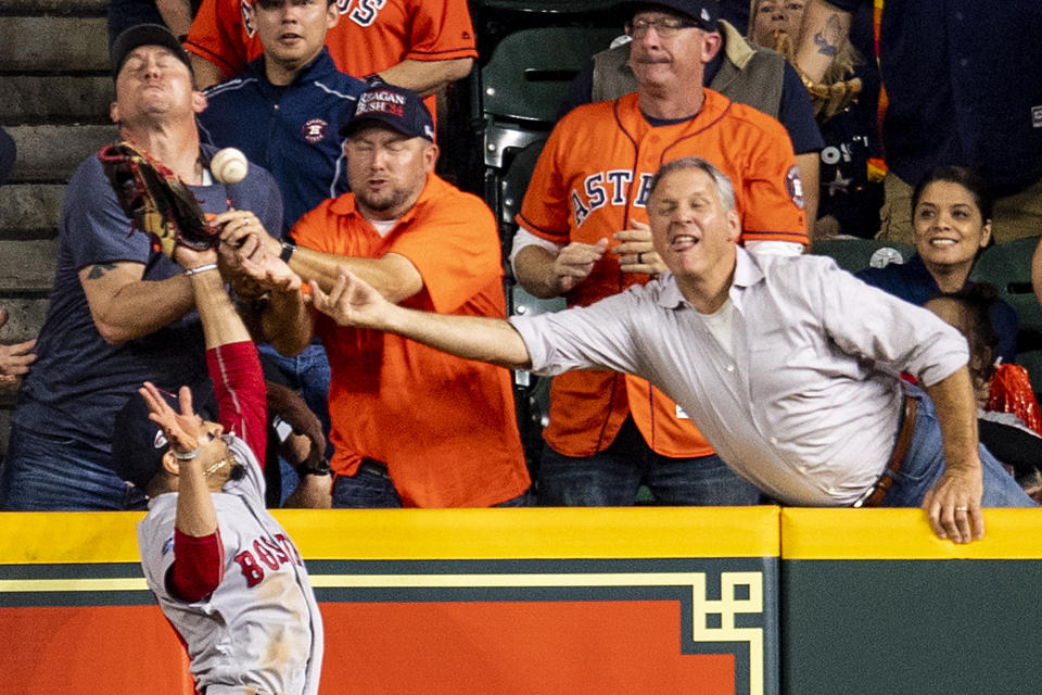 Fans reach as Mookie Betts attempts to catch a would-be homer hit by Jose Altuve. (Photo by Billie Weiss/Boston Red Sox/Getty Images)