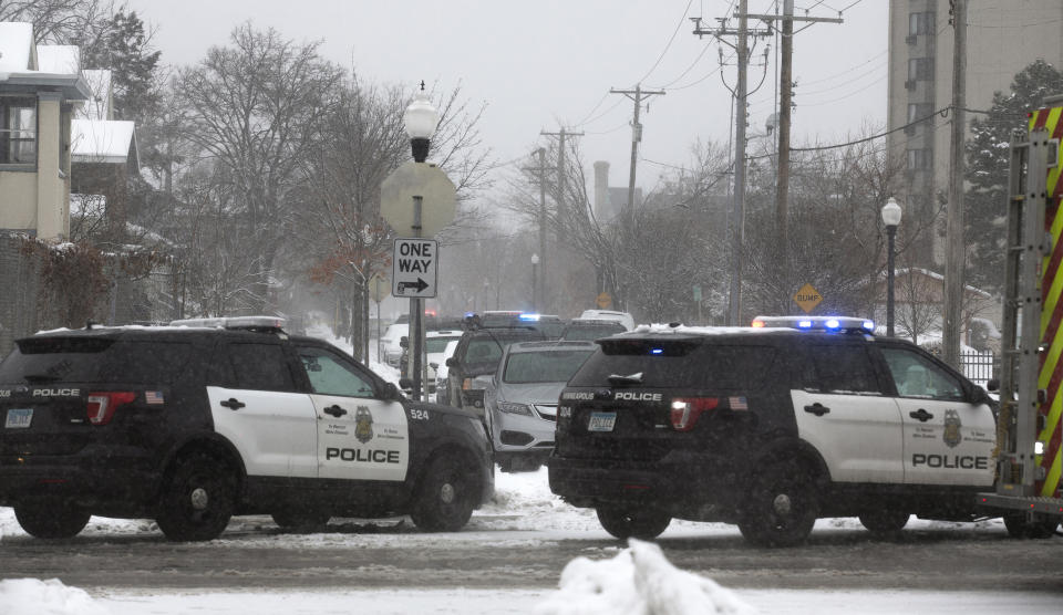 Authorities respond to the scene of a shooting on Oakland Avenue South, Sunday, Dec. 1, 2019, in Minneapolis. Two boys were found shot late Sunday morning outside the residence, where two adults were found dead later in the day. The two boys were also later pronounced dead, in what police are calling a "domestic related incident." (Kevin Martin/Star Tribune via AP)