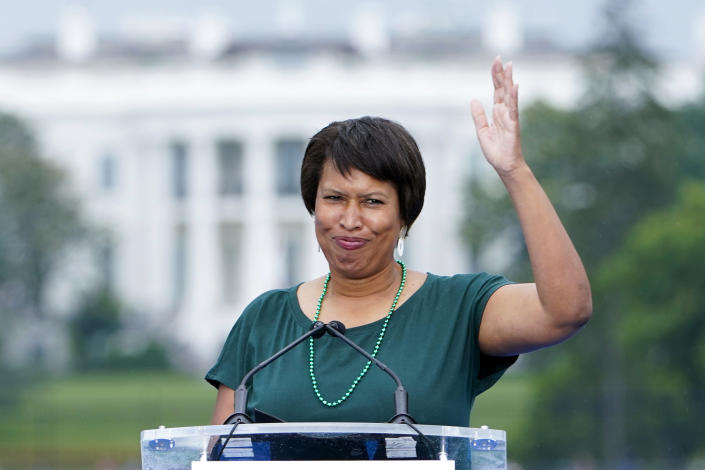 FILE - With the White House in the background, District of Columbia Mayor Muriel Bowser waves as she arrives to speak during the second March for Our Lives rally, June 11, 2022, in Washington. The expected move next week in Congress to overturn District of Columbia laws dealing with crime and voting reflects a larger political dynamic playing out across the country. (AP Photo/Manuel Balce Ceneta, File)
