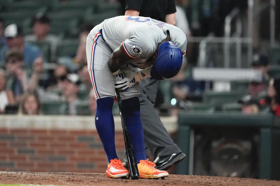 Texas Rangers' Adolis García reacts after striking out to end the Rangers' half of the eighth inning of a baseball game against the Atlanta Braves Friday, April 19, 2024, in Atlanta. (AP Photo/John Bazemore)