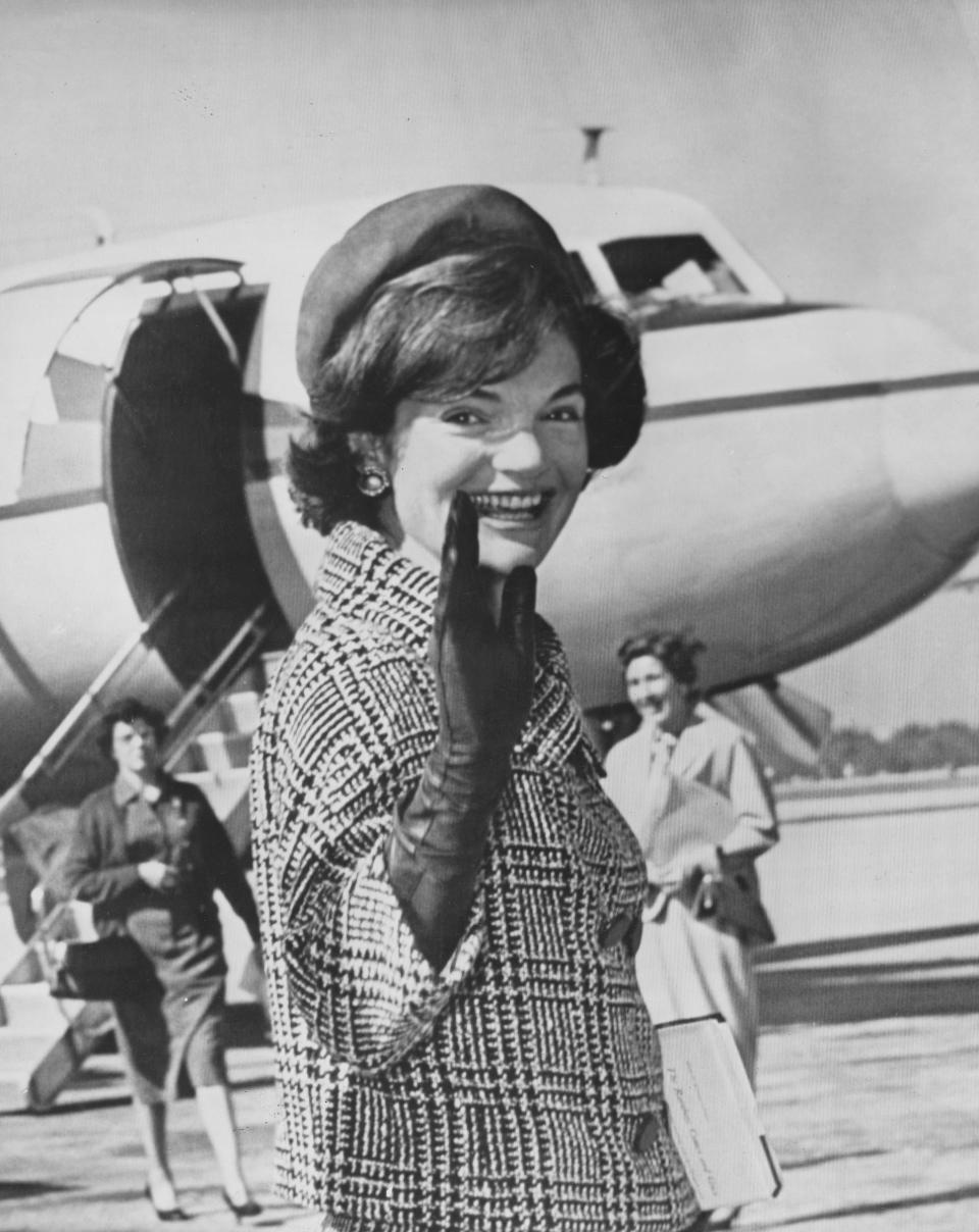 Mrs. Jacqueline Kennedy waves goodbye to a crowd on Jan. 18, 1961, at the West Palm Beach airport, where she was boarding President-elect John F. Kennedy's private plane, the Caroline, to Washington, D.C., for Kennedy's inaugural.