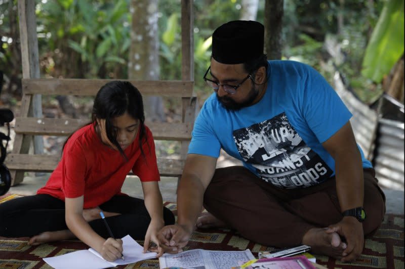 Walid (Megat Sharizal) teaches Aisha (Putri Qaseh Izwandy). Photo courtesy of Outsider Pictures