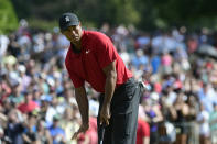 Tiger Woods motions for his putt for birdie to slow down as it passes the ninth hole during the final round of the Tour Championship golf tournament Sunday, Sept. 23, 2018, in Atlanta. (AP Photo/John Amis)