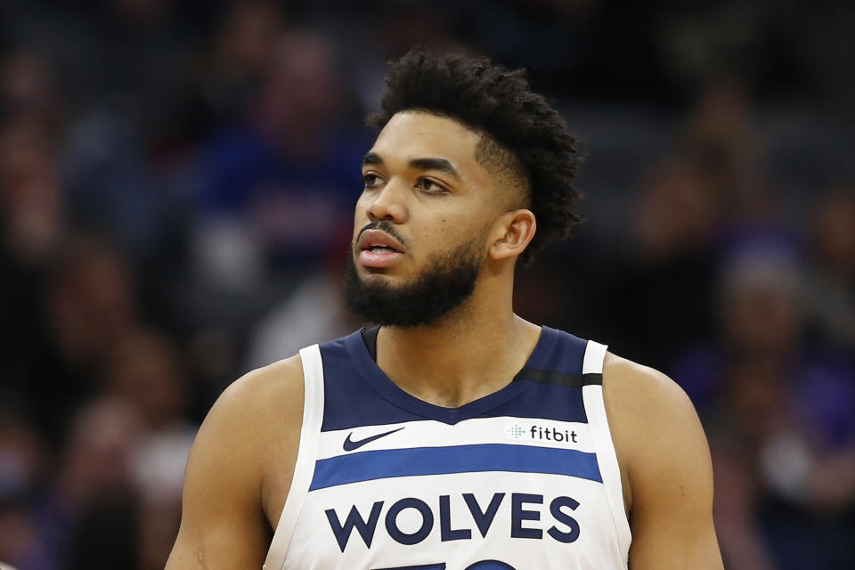 FILE - In this Feb. 3, 2020, file photo, Minnesota Timberwolves center Karl-Anthony Towns is shown during the second half of an NBA basketball game against the Sacramento Kings in Sacramento, Calif. Towns says his mother is hospitalized and in a medically-induced coma after contracting the new coronavirus. Towns talked about his mother's condition Wednesday, March 25, 2020, on his Instagram page and urged his followers to take COVID-19 seriously and practice social distancing.  (AP Photo/Rich Pedroncelli, File)