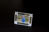 A framed photo of Taya Bruell is photographed in Santa Barbara, Calif., Wednesday, March 9, 2022. Taya killed herself when she was 14. Taya was a bright, precocious student who had started struggling with mental health issues at about 11, according to her father. At the time, the family lived in Boulder, Colorado where Taya was hospitalized at one point for psychiatric care but kept up the trappings of a model student: She got straight As, was co-leader of her high school writing club and in her spare time taught senior citizens to use computers. (AP Photo/Jae C. Hong)