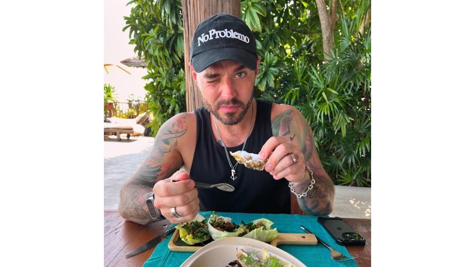 Matt Willis wearing a black tank top eating breakfast